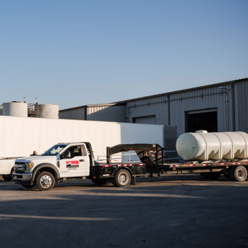 Midtex Oil truck performing used oil collection at a commercial facility.